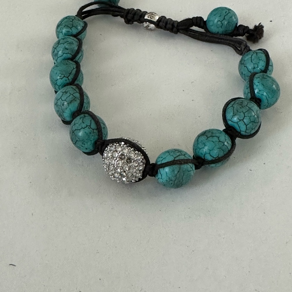 Turquoise beaded bracelet strung with waxed cord with crystal accent bead